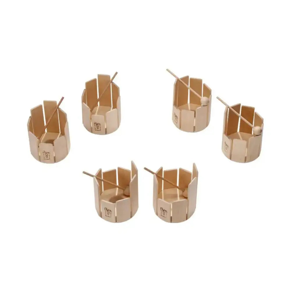 Set of six small wooden stir drums with mallets on a white background