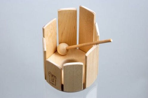 Wooden stir drum xylophone musical instrument with a mallet on a light blue background