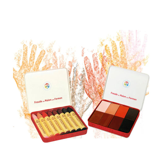 Set of skin tone crayons in a red case with a white lid on a white background