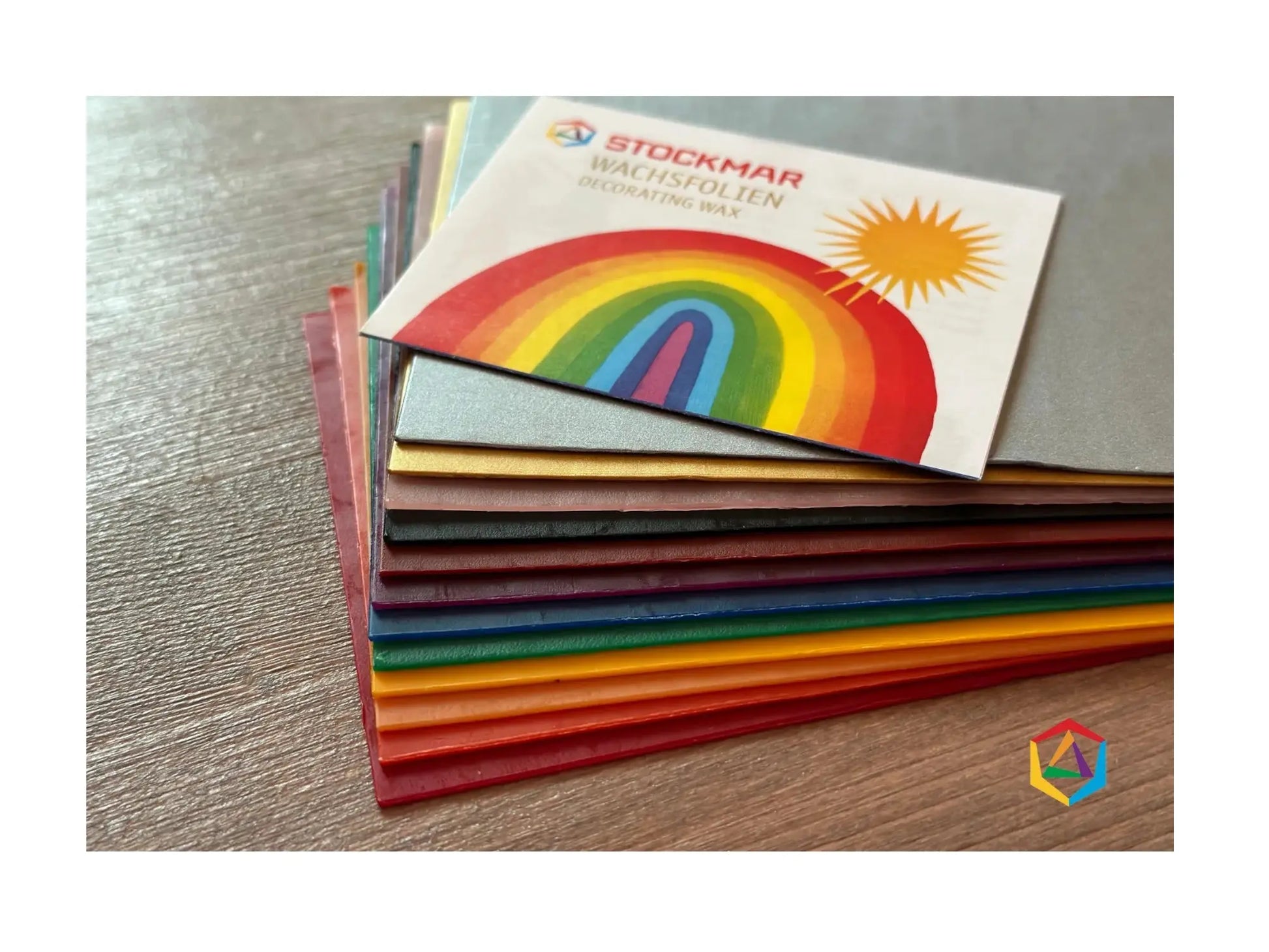 Stockmar Decorating Wax in large, wide sheets fanned out on dark table top to show colors