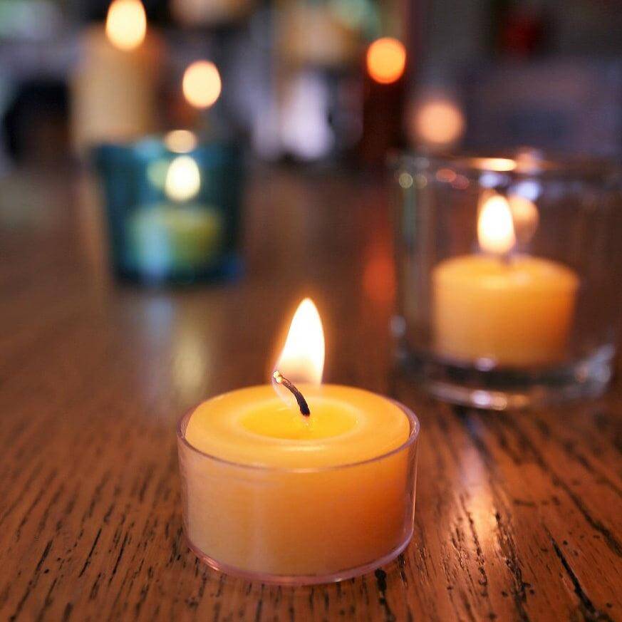 Candle on a wooden surface with blurred background