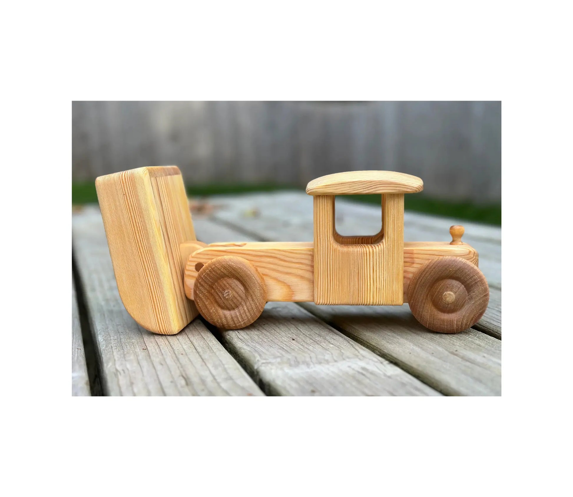Wooden toy truck on a wooden surface with a blurred background