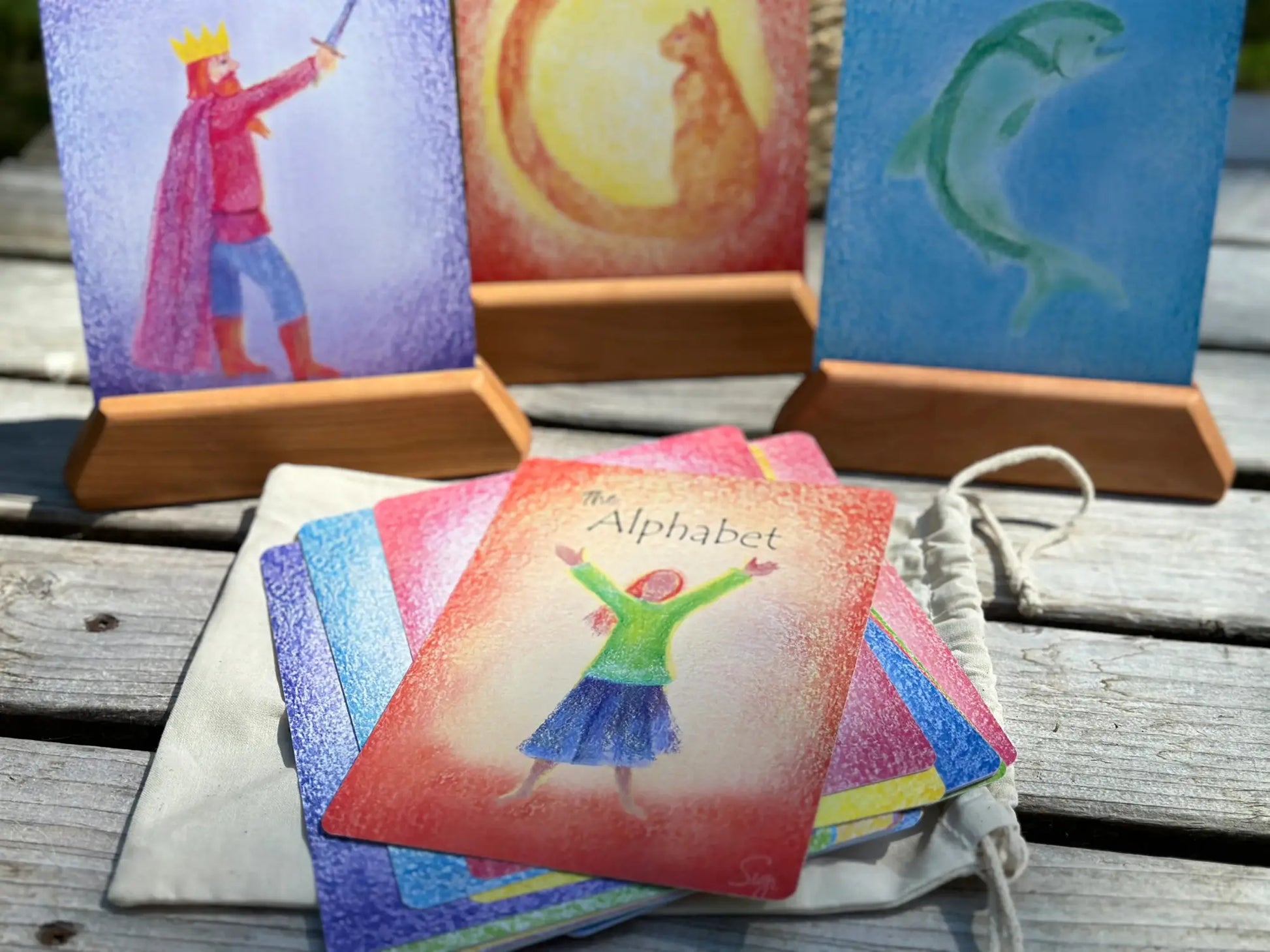 Waldorf Fairy Tale illustrations as letters for alphabet cards on rustic tabletop