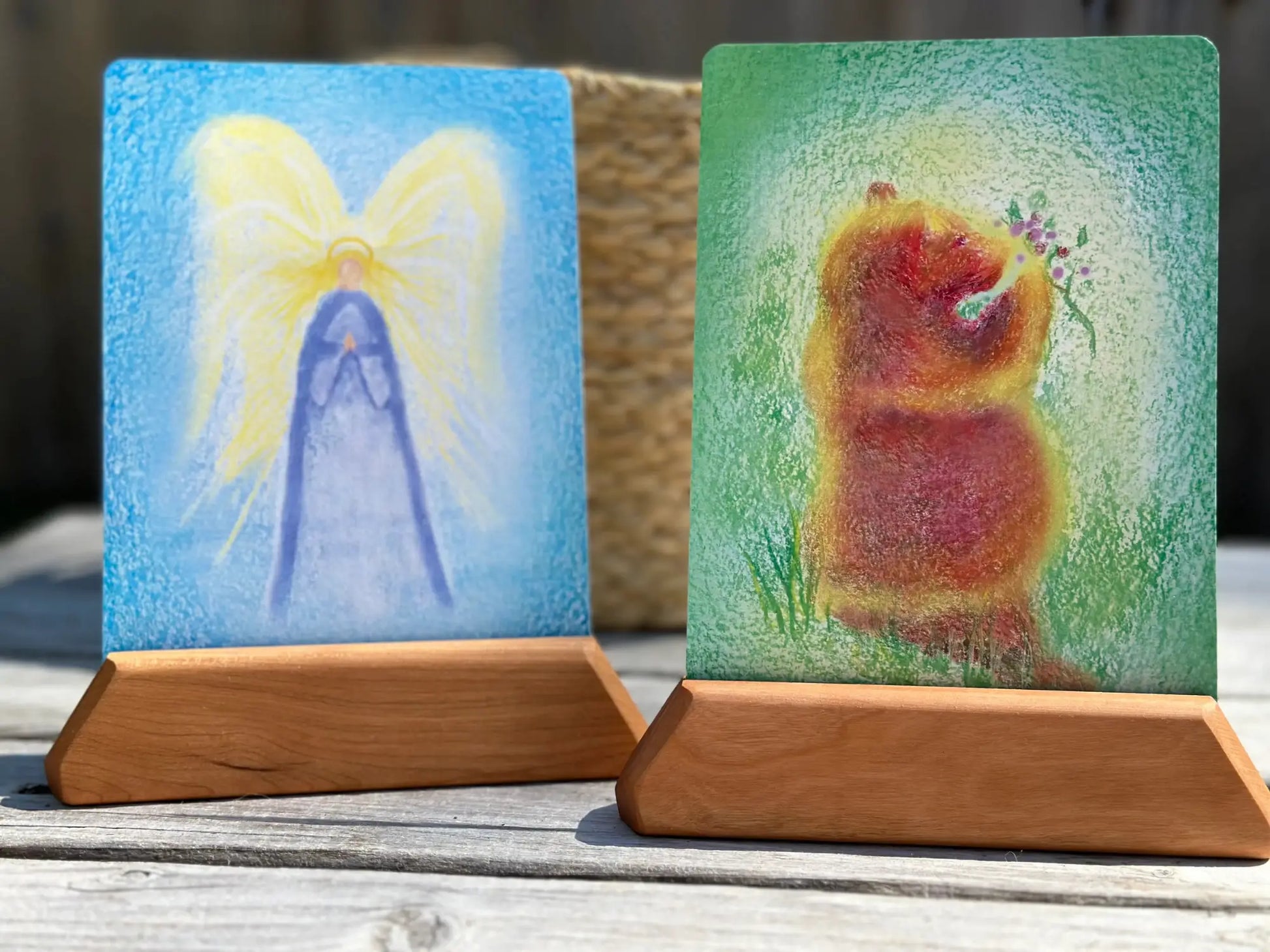An angle and a bear illustration in wooden card holders for the Waldorf letters A and B