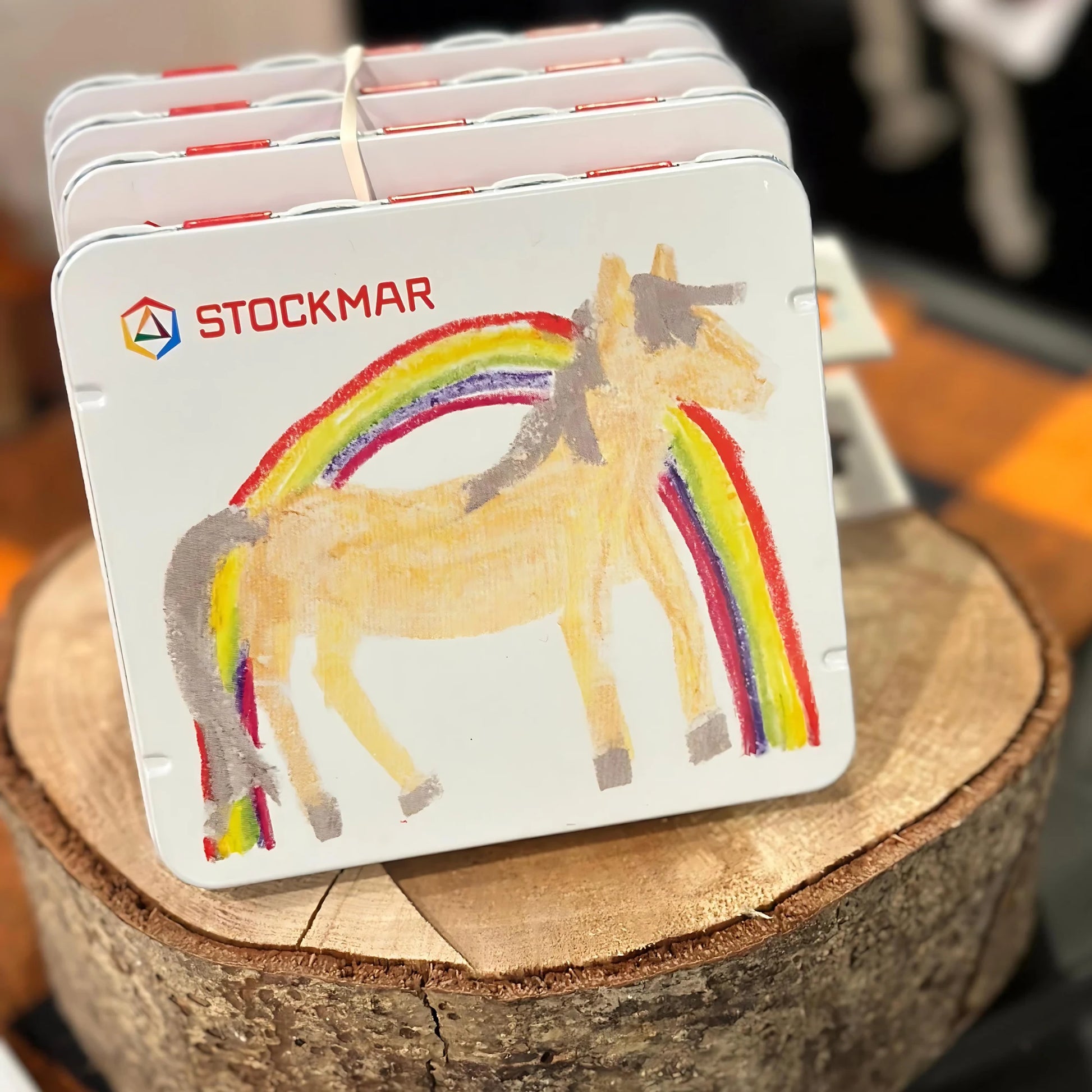 Set of Stockmar coasters with a horse and rainbow design on a wooden surface.