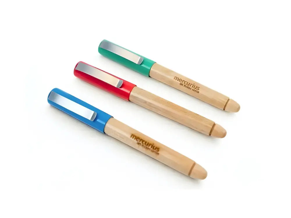 Three wooden barrel Greenfield calligraphy pens in blue, red, and green on a white background