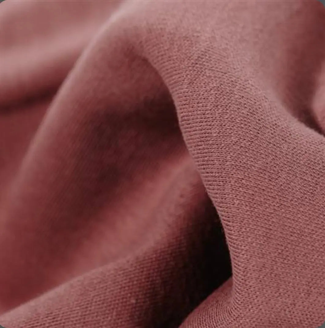 Close-up of textured red-brown organic cotton tricot dollmaking fabric