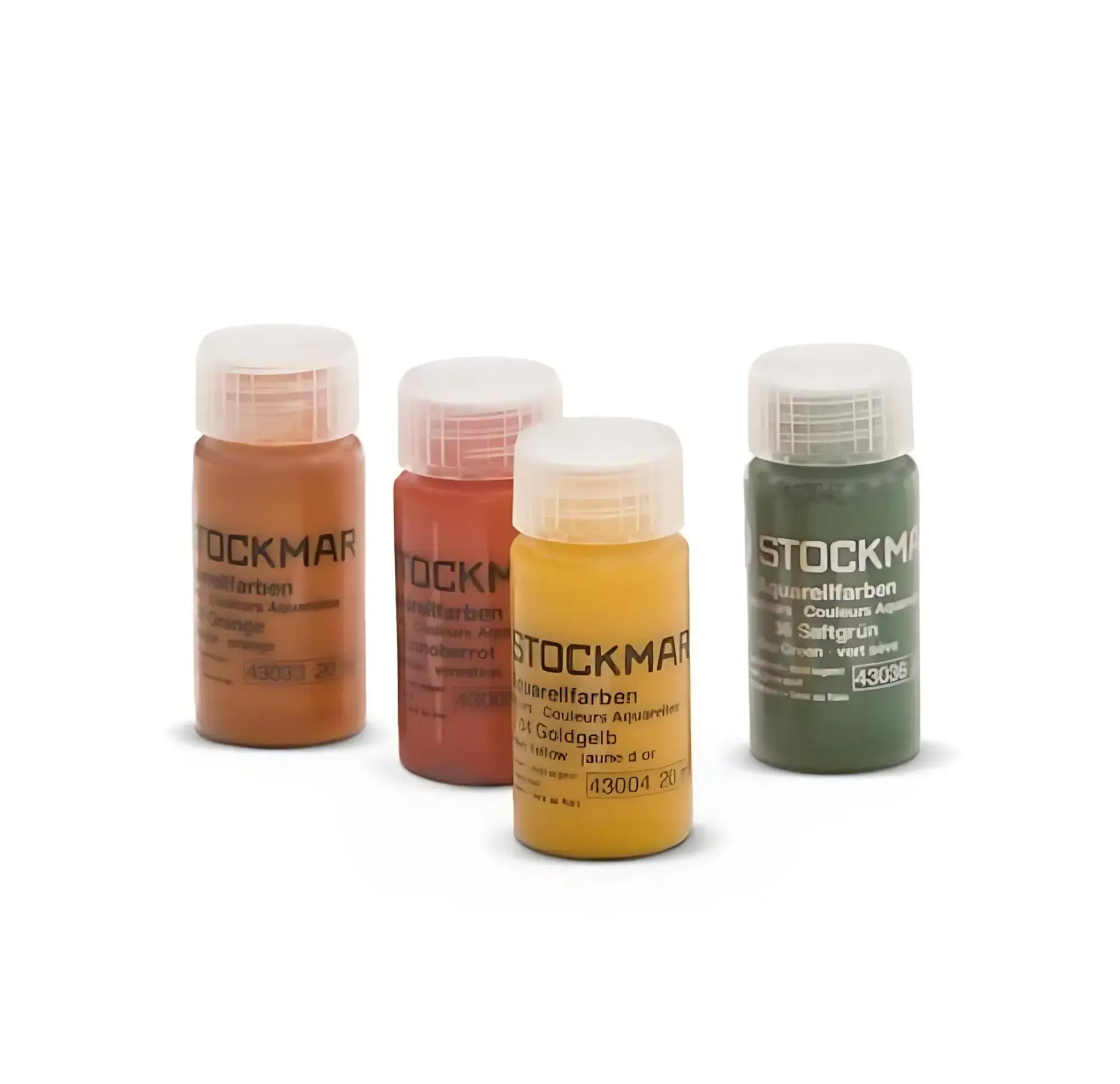 Four bottles of Stockmar watercolor paint on a white background