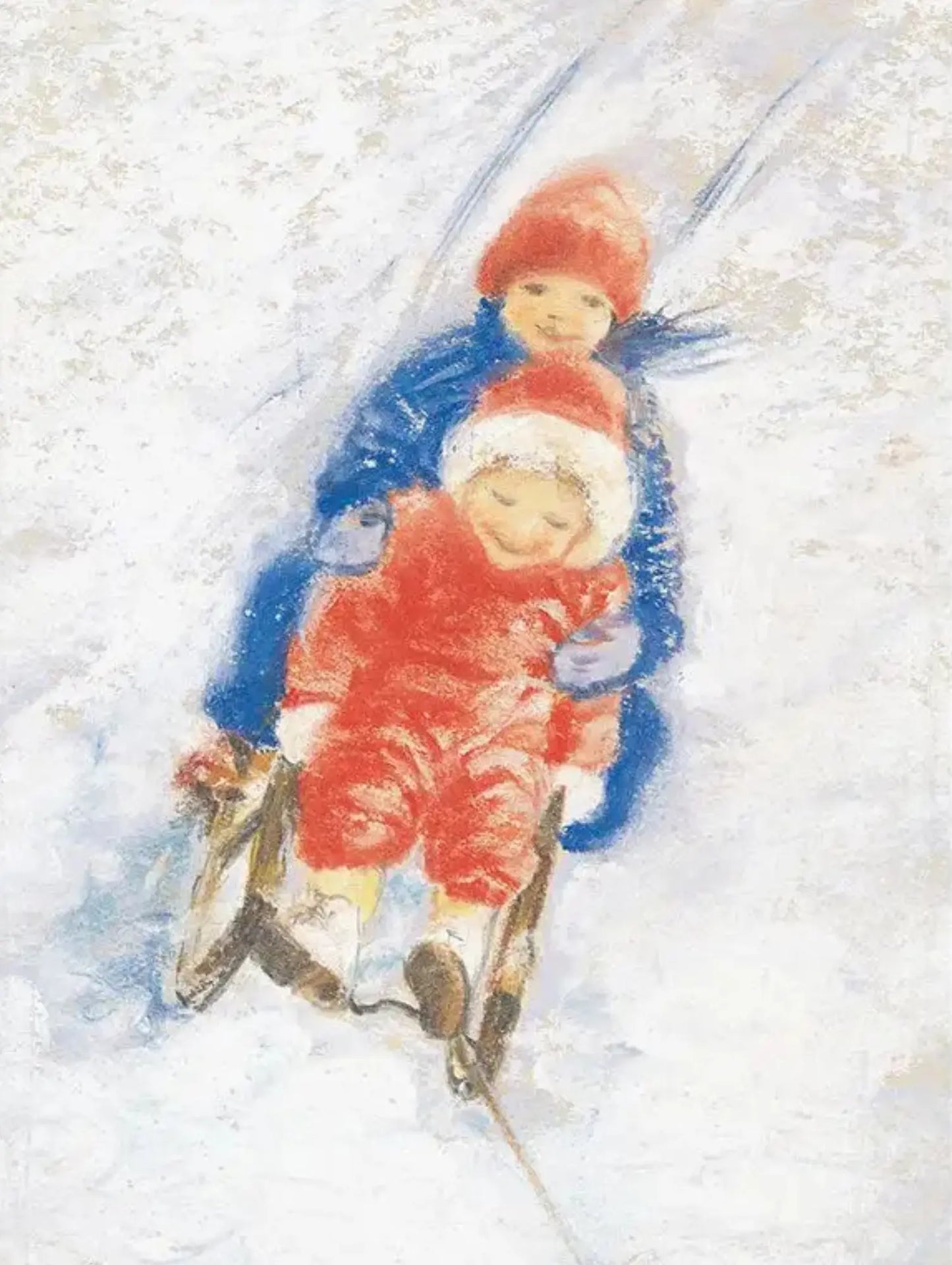 Two children in blue and red snowsuits and hats sledding down a snowy hill.