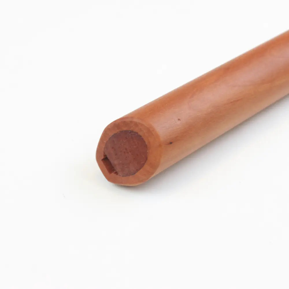 Wooden pear wood pentatonic flute on a white background