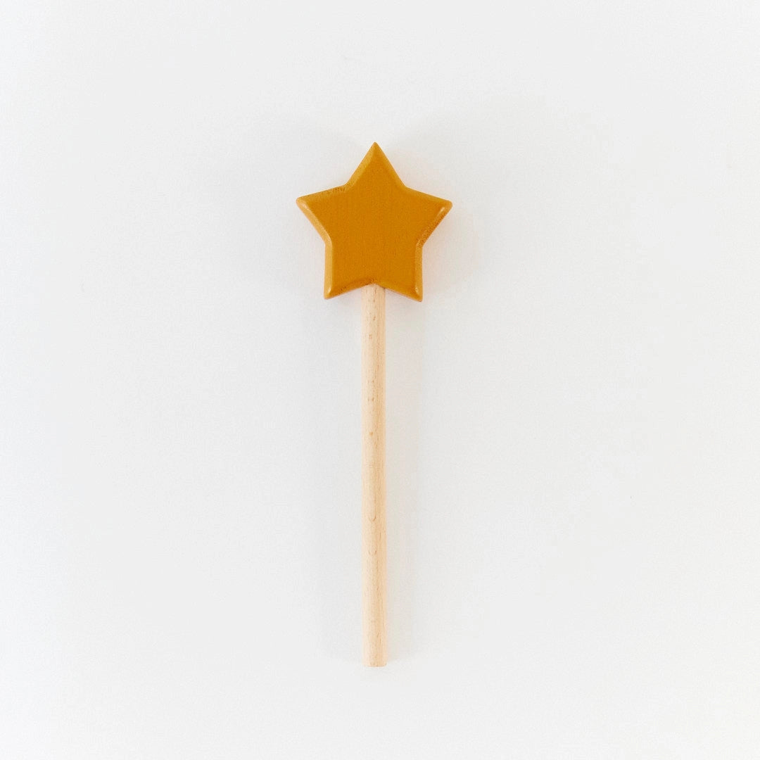 Yellow star-shaped wand for children on a white background