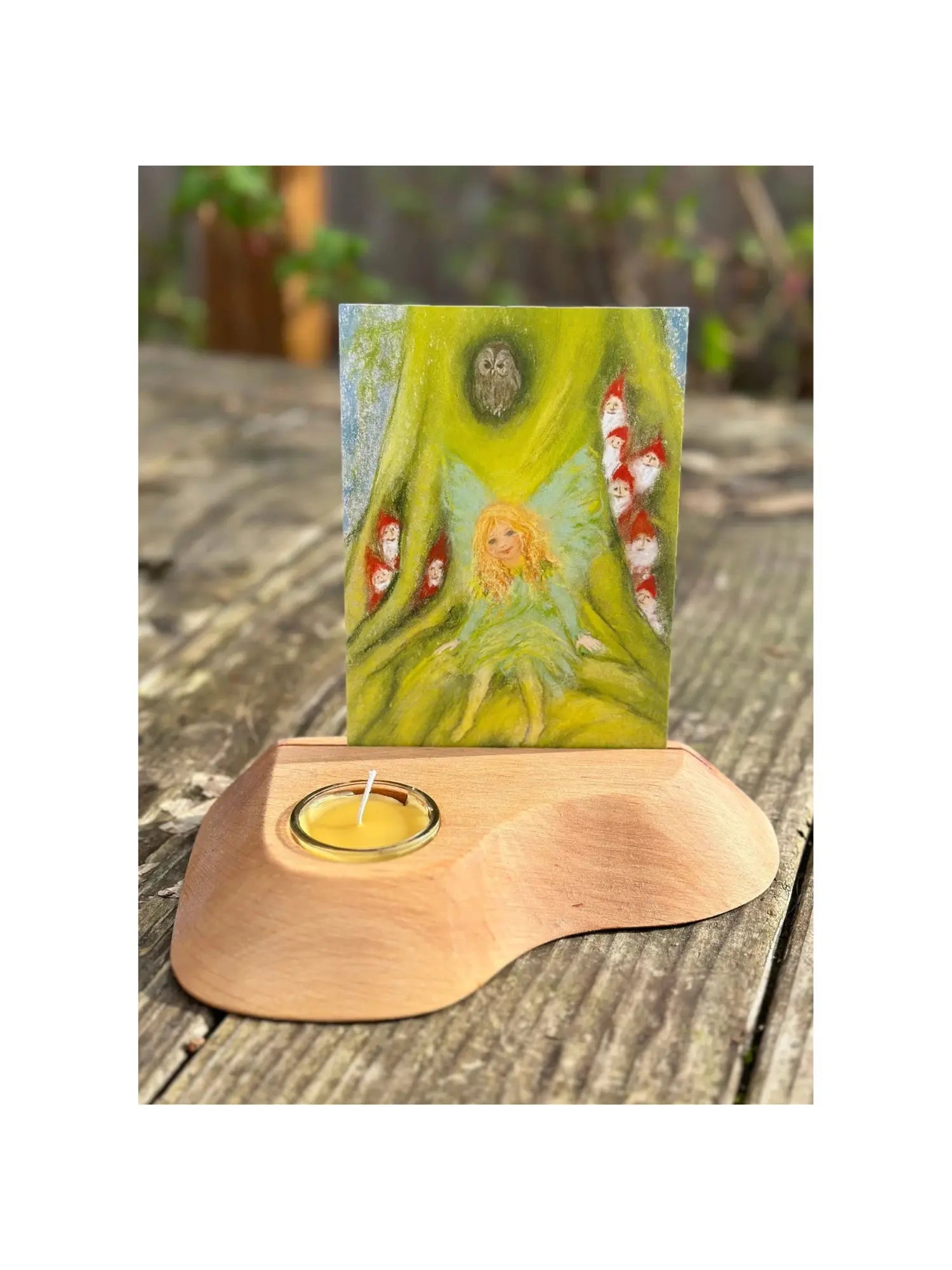 Alderwood Photo and Postcard Holder with Tealight and a postcard of fairy adn gnomes on rustic outdoor wooden table
