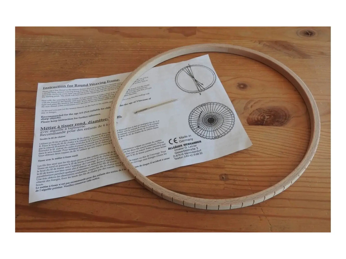 Wooden loom with instructions on a wooden surface