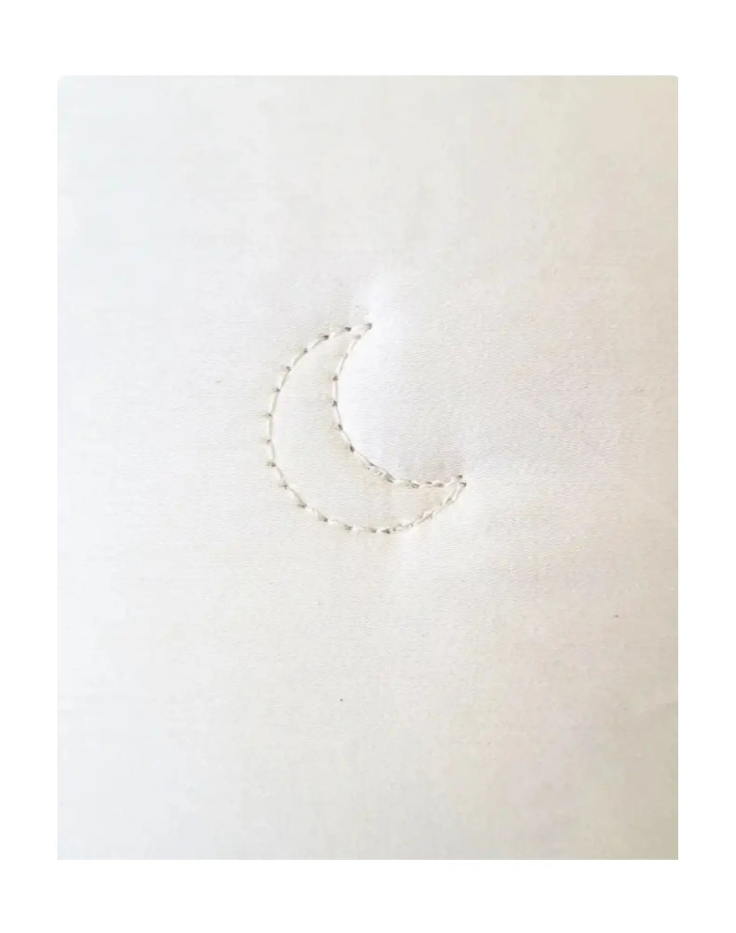 Close-up of crescent stitch on alpaca wool comforter showing sewn-through construction detail