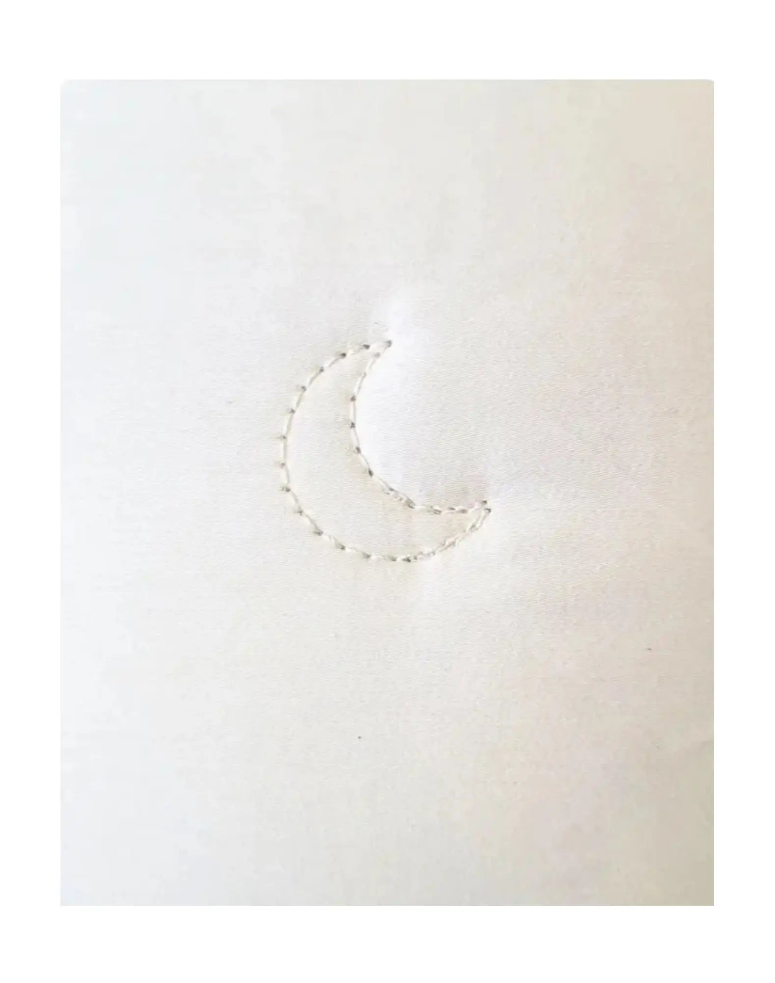 Close-up of crescent stitch on alpaca wool comforter showing sewn-through construction detail