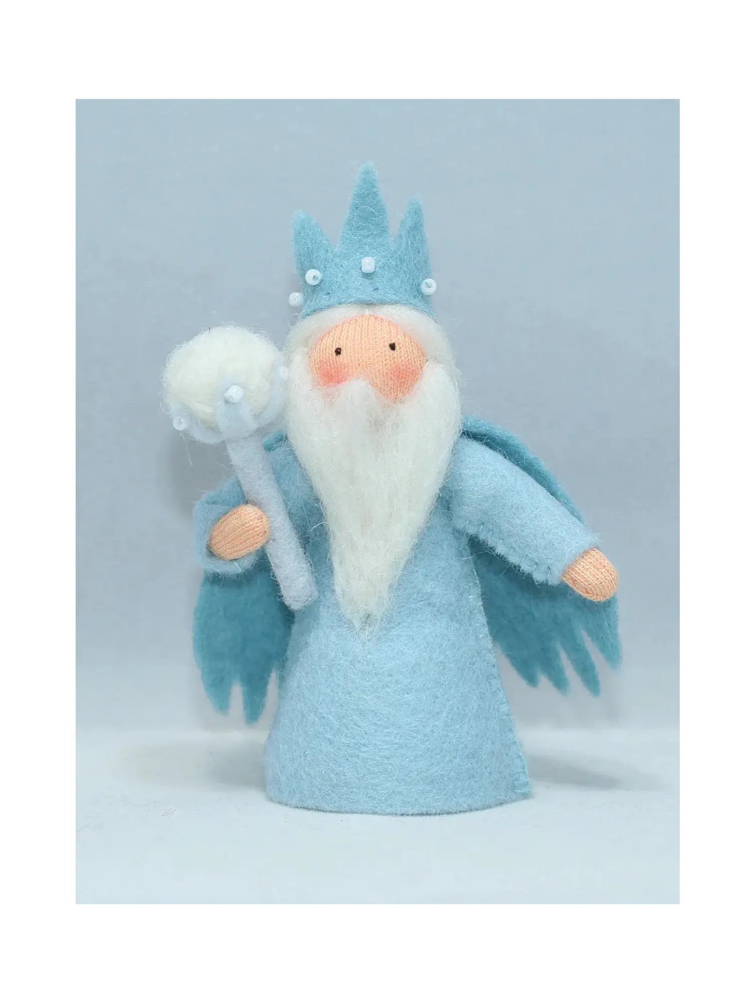 King Winter in a blue gown and cape with crown, snowball scepter, and long, white beard