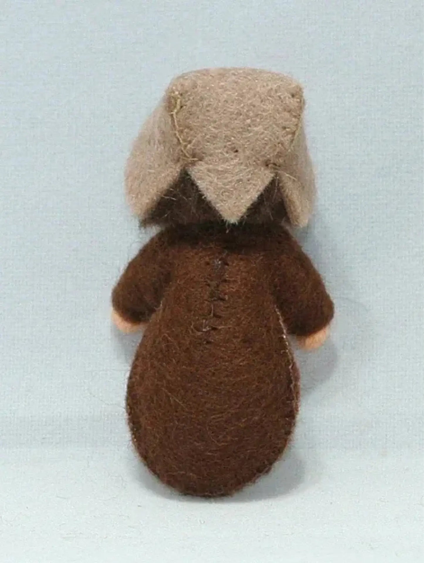 Back of the a seed baby ambrosia doll for nature tables on a white background