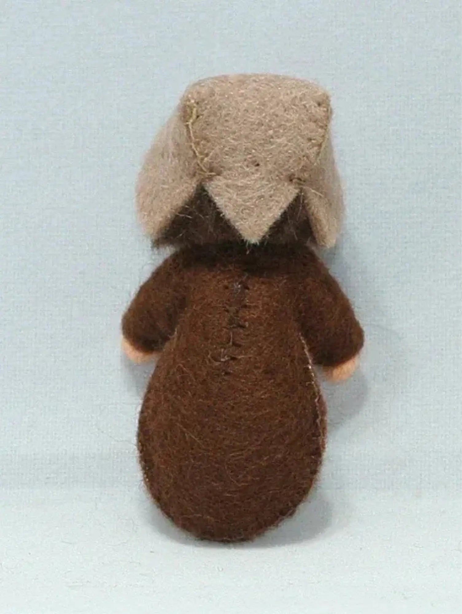 Back of the a seed baby ambrosia doll for nature tables on a white background