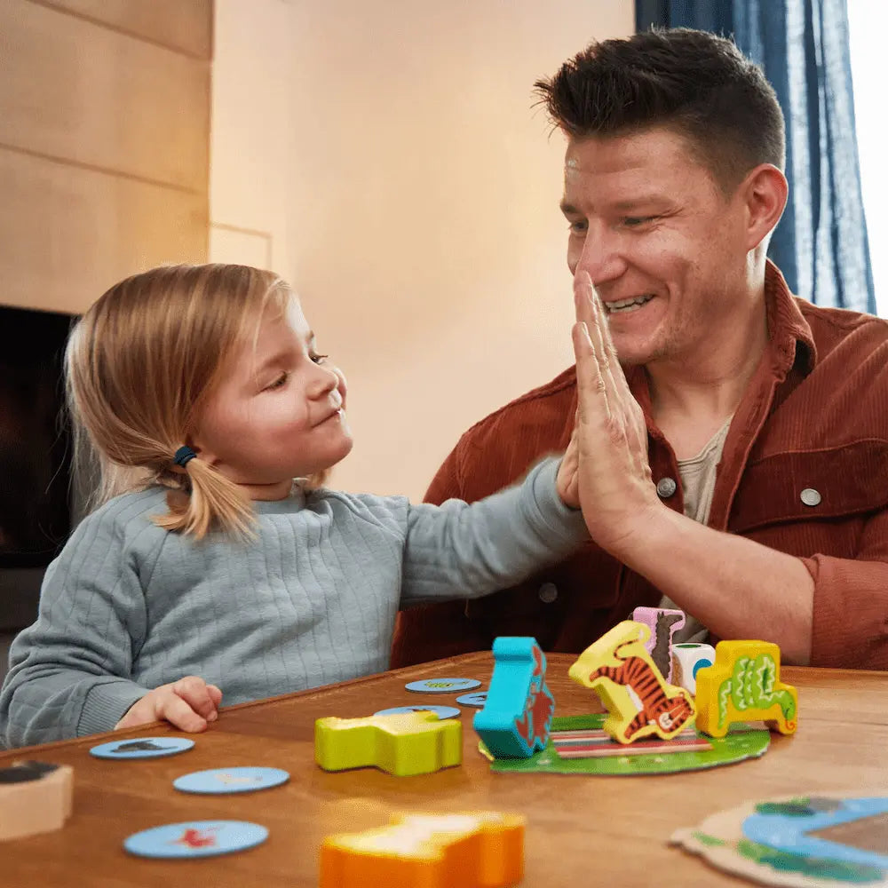 Child and parent playing Animal Upon Animal Junior balance game together