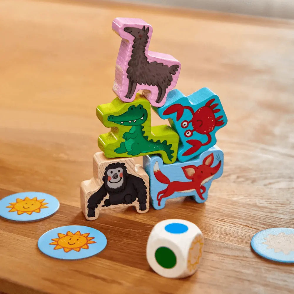 Close-up of wooden animal pieces and die from Animal Upon Animal Junior stacking game