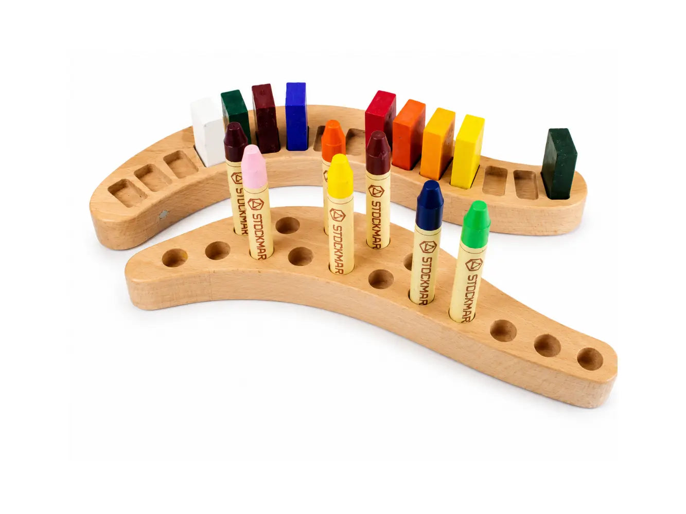 Wooden crayon holder with colorful Stockmar crayons on a white background