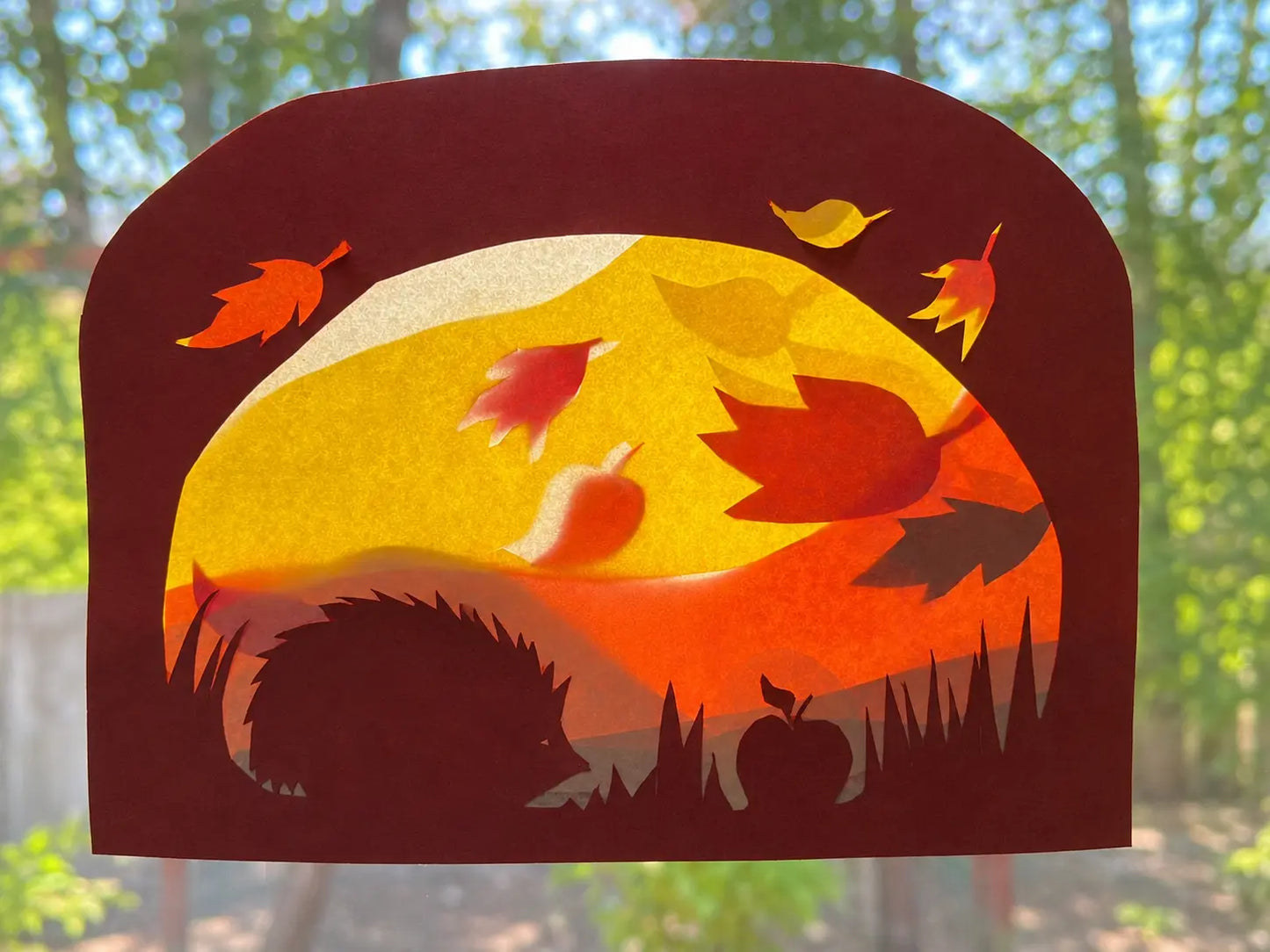 Autumn Transparent Window Scene of a Hedgehog, apple and autumn leaves falling