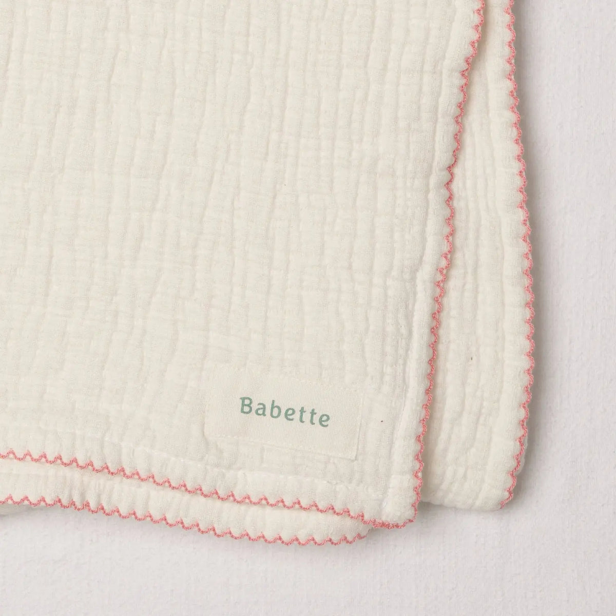 Babette thick plush white baby wrap with peony scalloped trim and soft textured cotton fabric