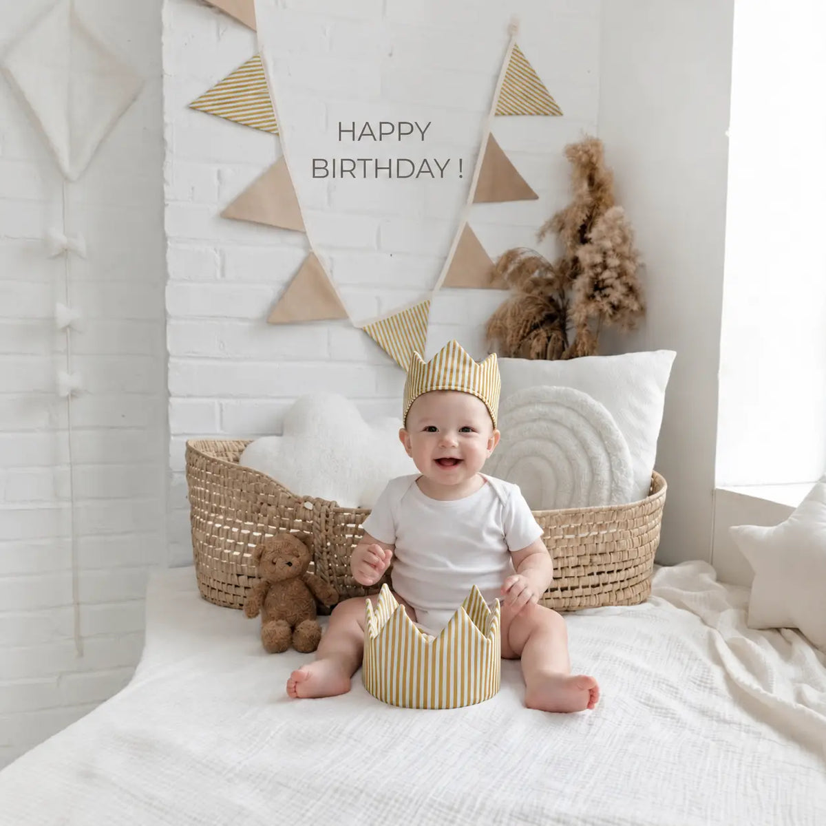 Baby wearing a golden mustard striped linen crown for a birthday celebration