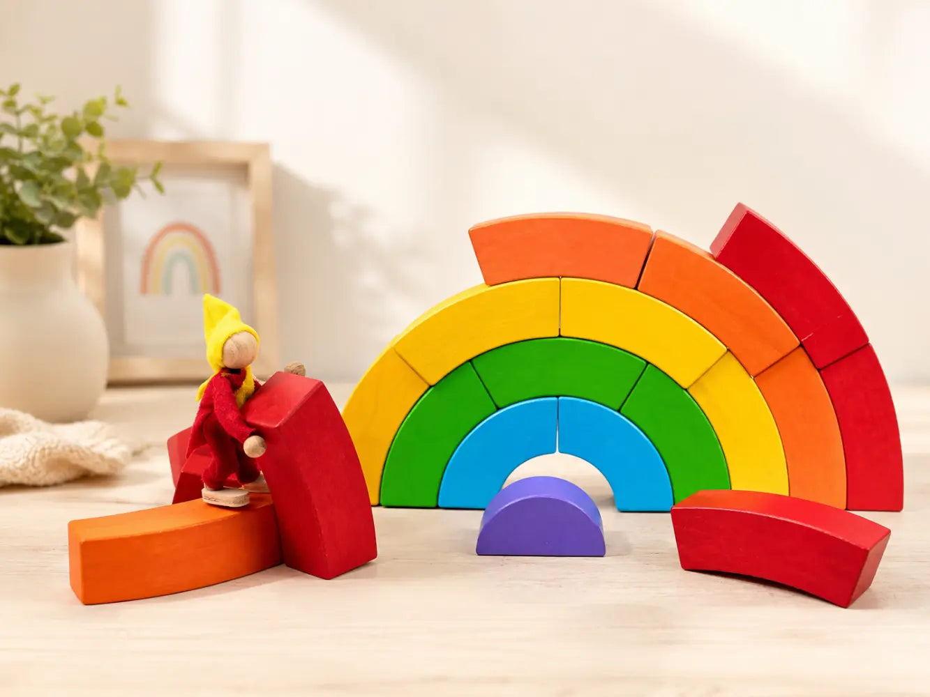 BAJO wooden rainbow blocks arranged with a small wooden doll for imaginative small-world play