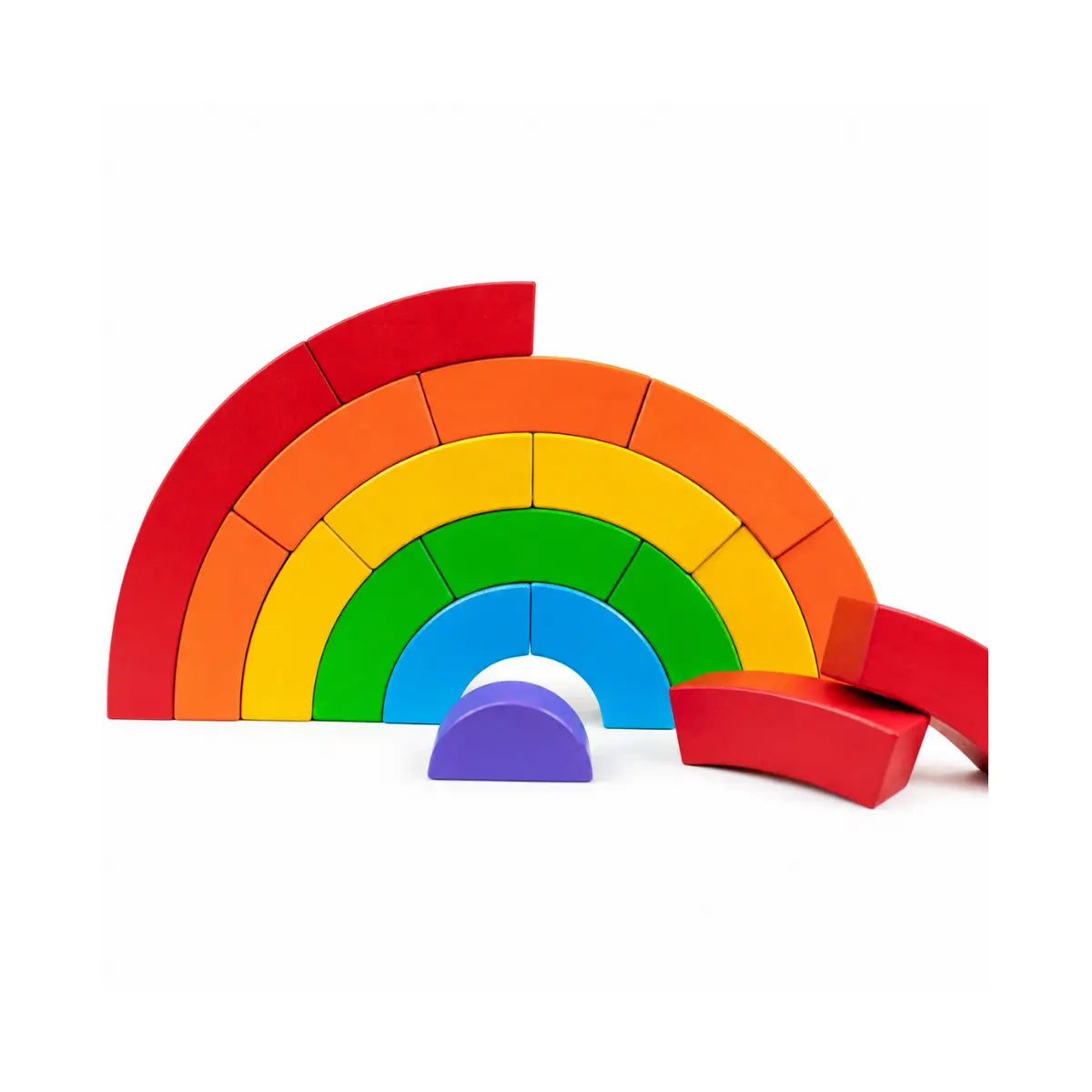 BAJO wooden rainbow blocks arranged as a partial arch with loose curved pieces for open-ended building