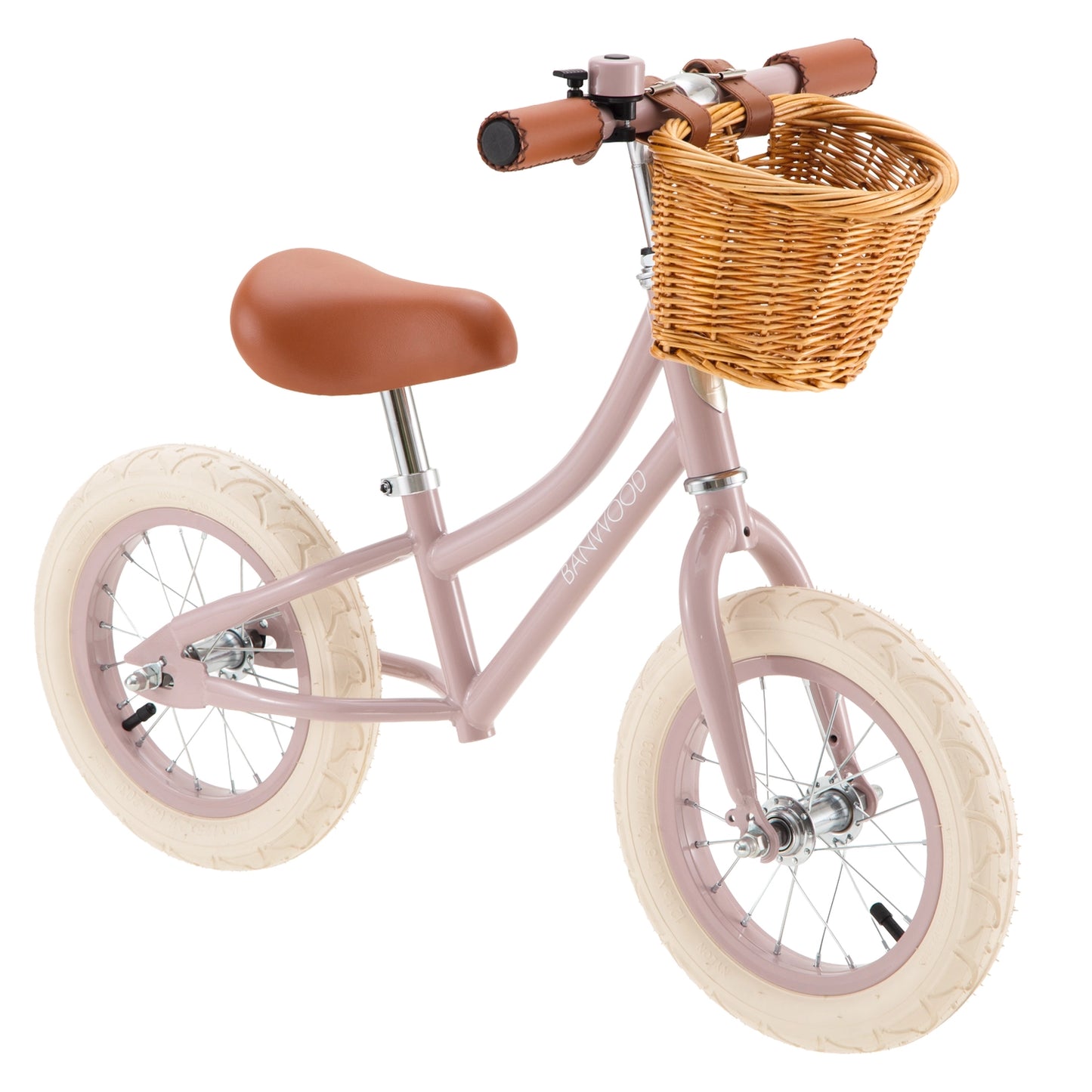 Pink balance bike with a wicker basket on a white background
