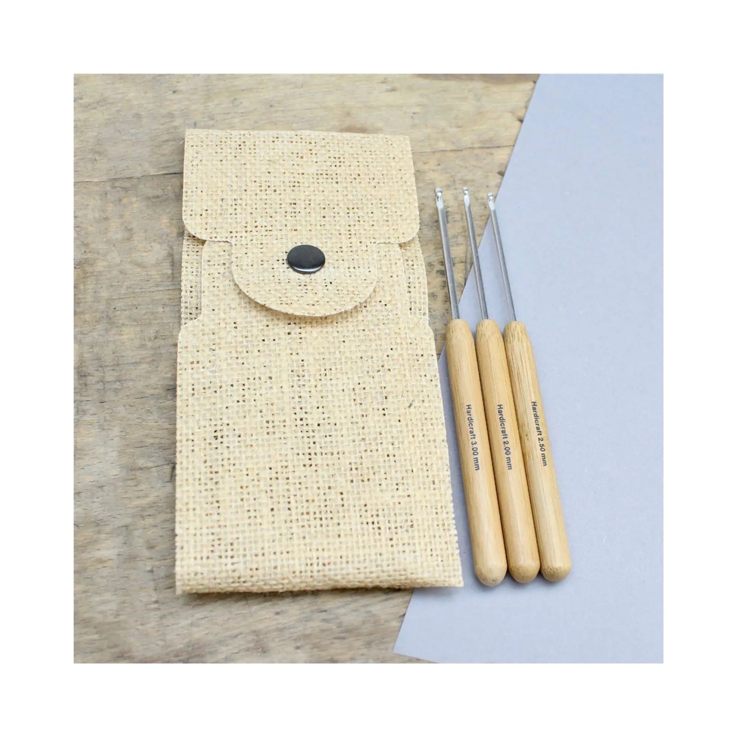 Bamboo handle aluminum crochet hook set shown with closed natural burlap pouch and fine aluminum hook tips