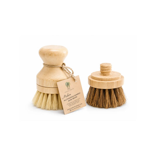 Bamboo dish brush with light sisal bristles beside a dark palm and sisal replacement scrubber head.