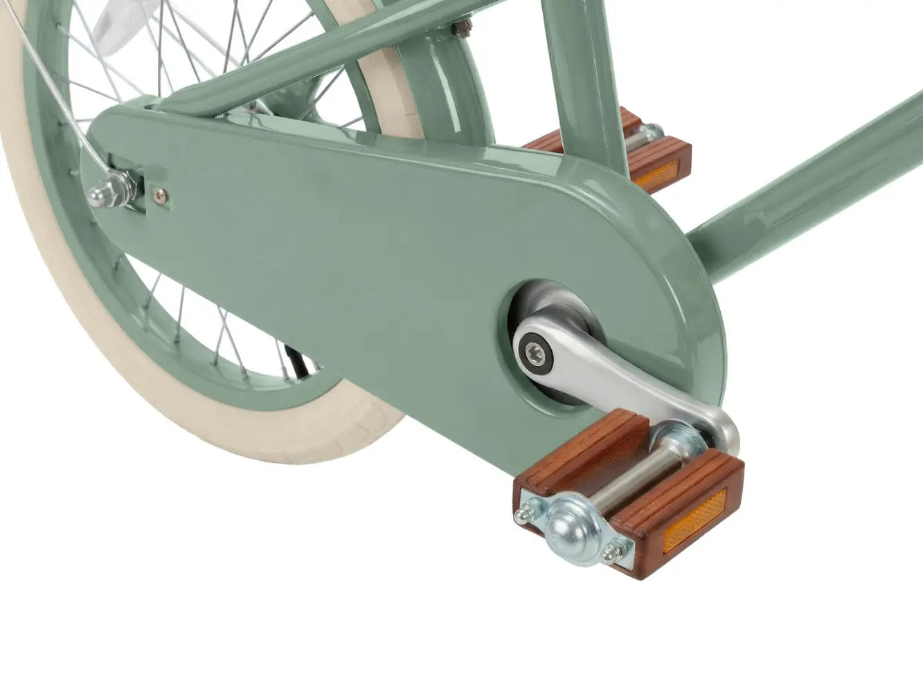 Close-up of a wooden bicycle pedal and chain mechanism on a white background