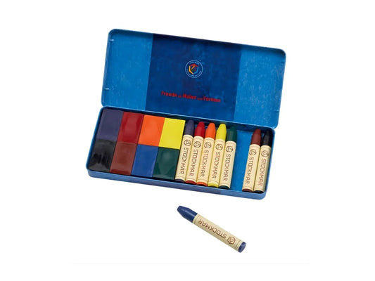 Stockmar Standard 8 color beeswax crayons and wax blocks arranged in an open blue tin