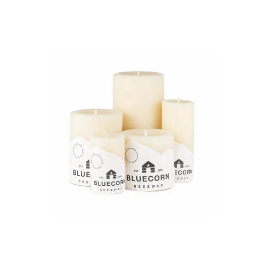 Three white candles with Bluecorn Bee蜡烛 branding on a white background