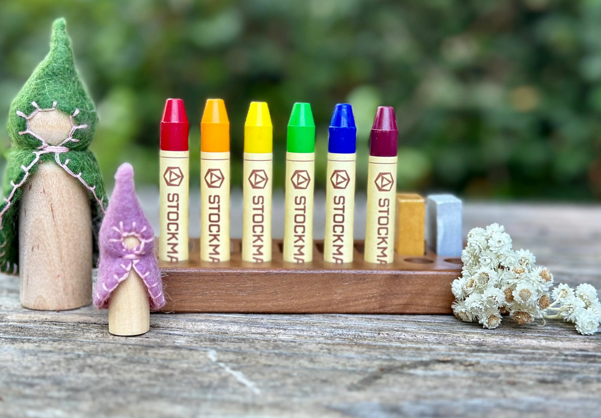 Stockmar beeswax stick crayons in wooden holder with Waldorf play scene
