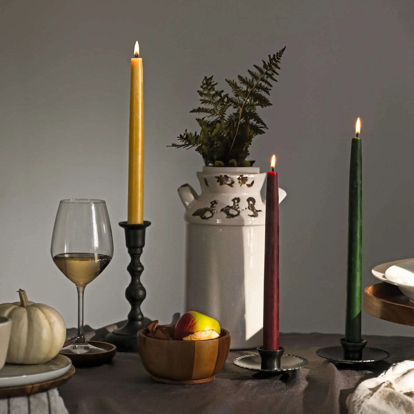 beeswax taper candles on a holiday table setting