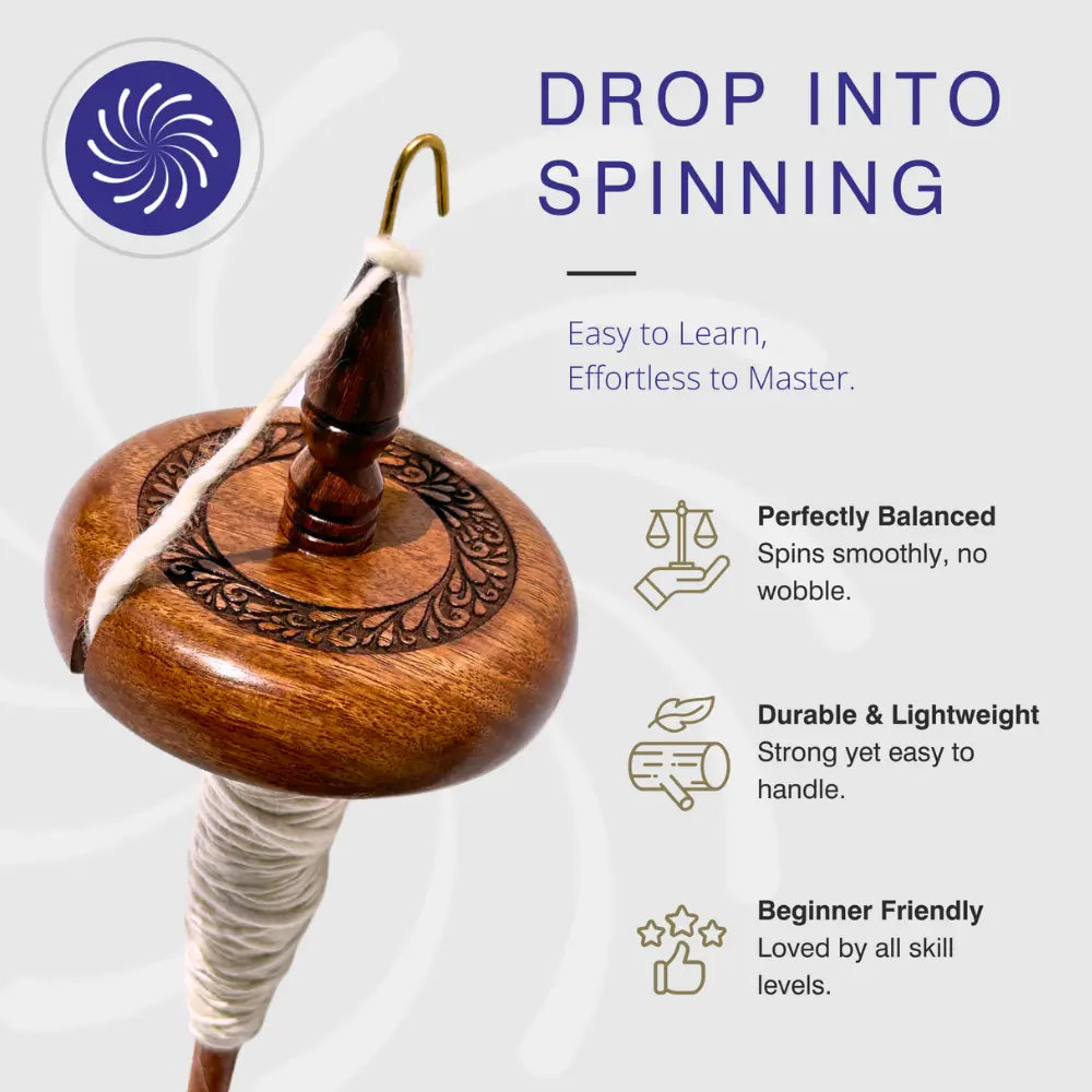 Wooden top whorl drop spindle with white yarn on a white background
