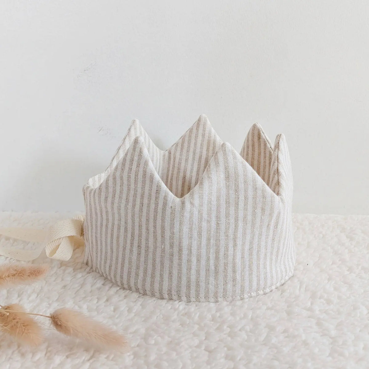 Beige striped linen dress-up crown styled on a soft neutral background