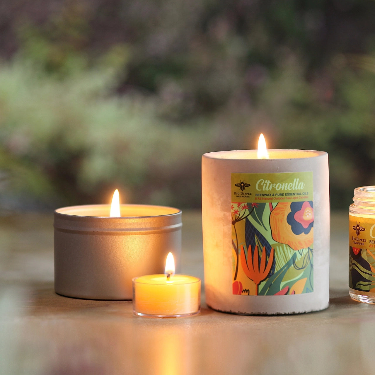 citronella candle in metal tin on a blurred background