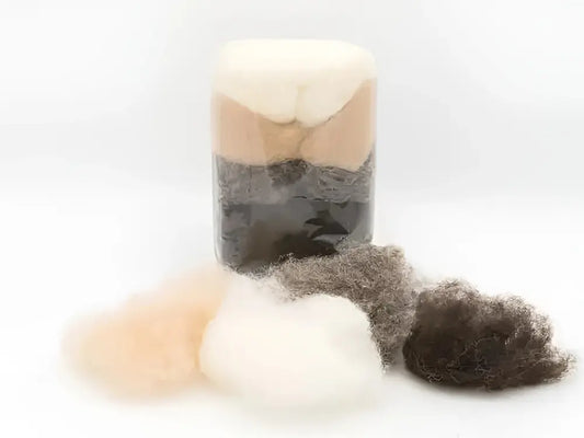 Organic earth tone wool from Filges in a bag and loose on a white background