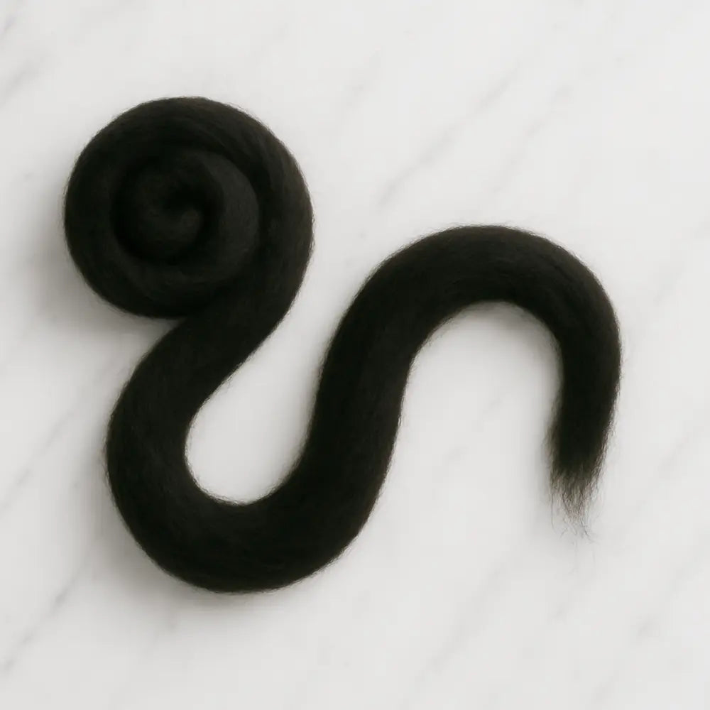 Coiled bundle of black superfine Merino wool sliver fiber for spinning and felting