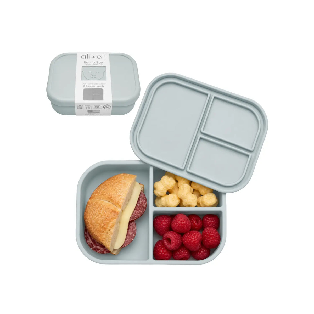 Light blue Ali+Oli Bear silicone bento box with three compartments filled with lunch foods.