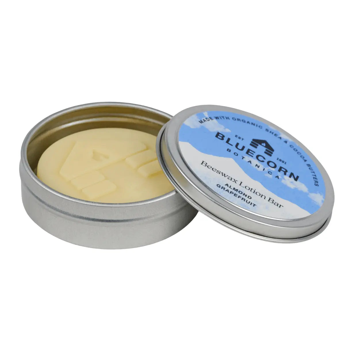 Open tin of Bluecorn Botanica Almond Grapefruit Beeswax Lotion Bar