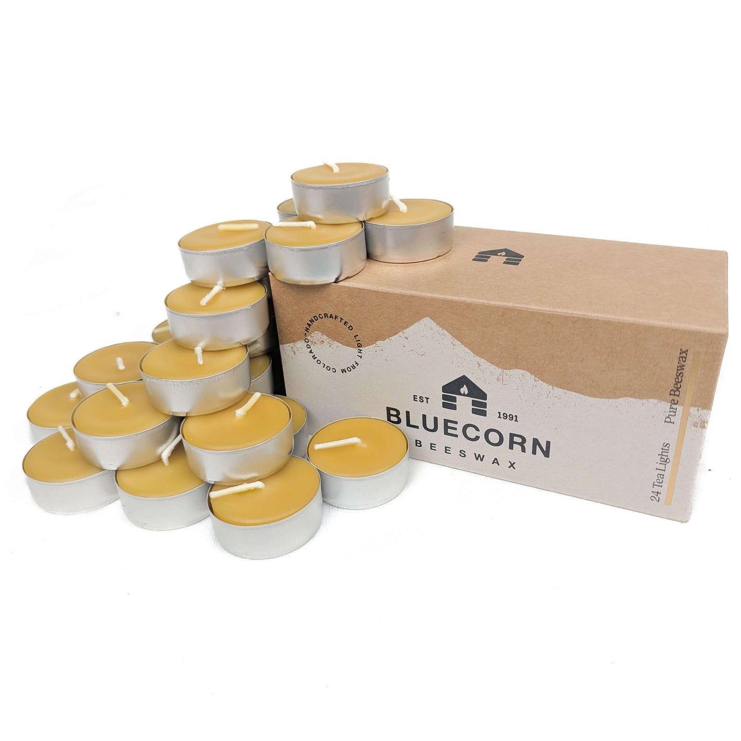 Tea lights with a cardboard box labeled 'Bluecorn Beeswax' on a white background
