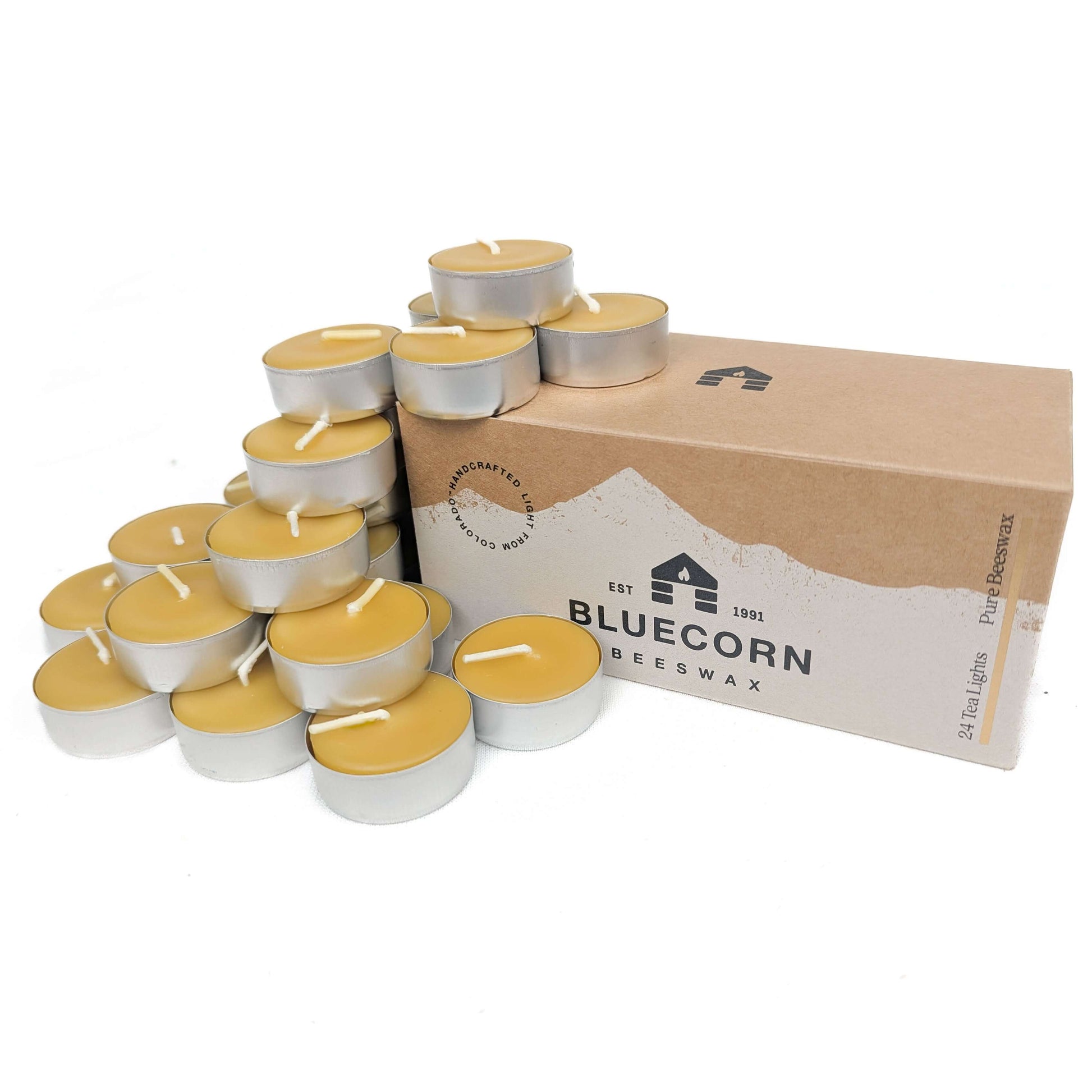 Tea lights with a cardboard box labeled 'Bluecorn Beeswax' on a white background
