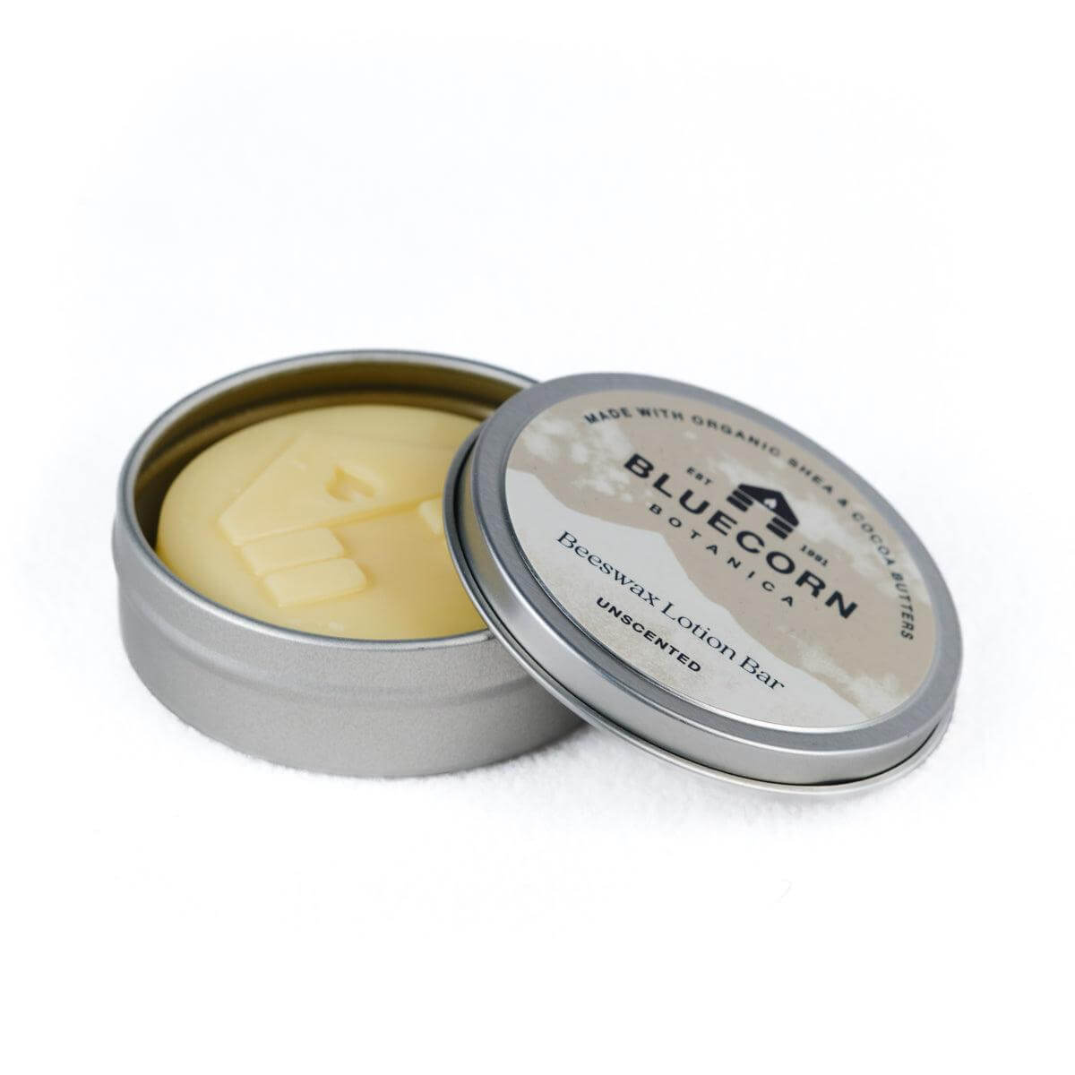 Open tin of Bluecorn Botanica Unscented Beeswax Lotion Bar