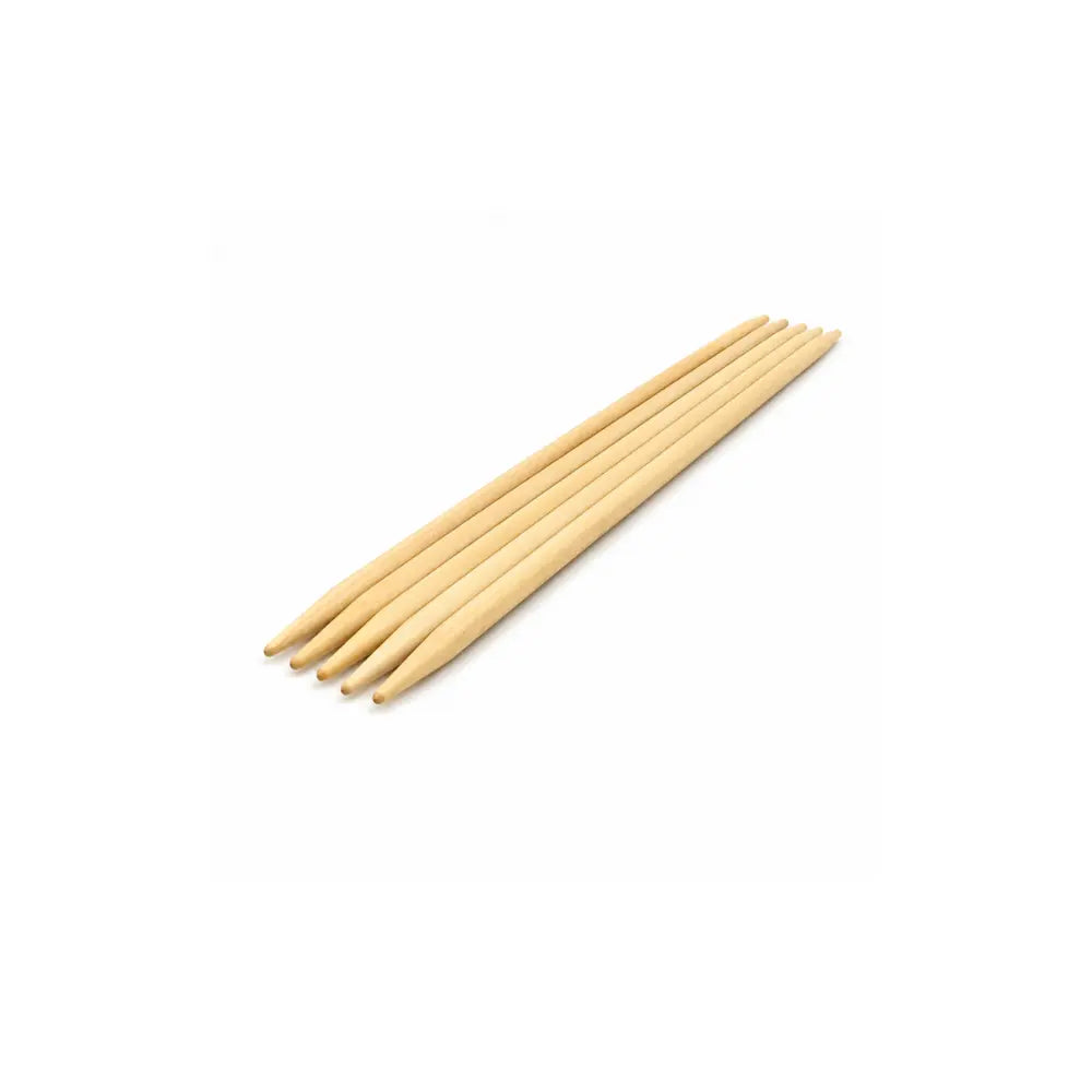 Brittany 10 inch double pointed wooden knitting needles arranged on a white background.