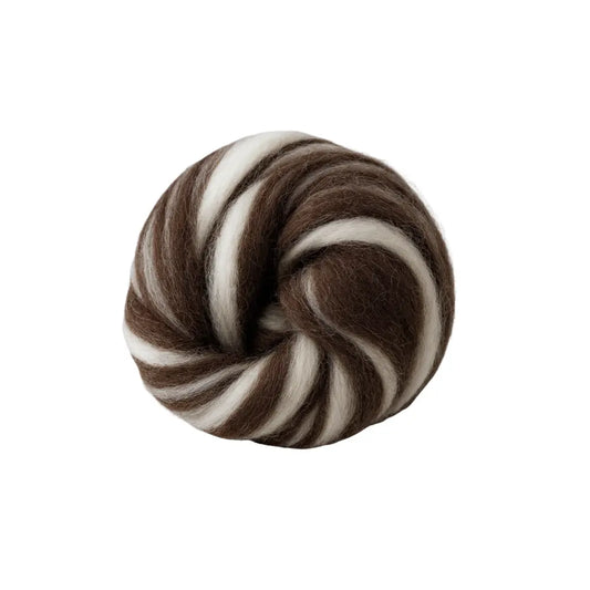 Spool of brown and white yarn on a white background